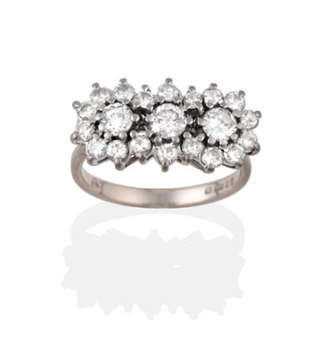 Lot 2166 - An 18 Carat White Gold Diamond Cluster Ring, a central row of three round brilliant cut...