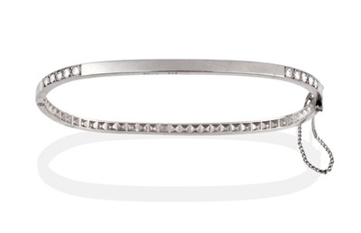 Lot 2168 - A Platinum and Diamond Bangle, the tv shaped bangle inset with five round brilliant cut diamonds to