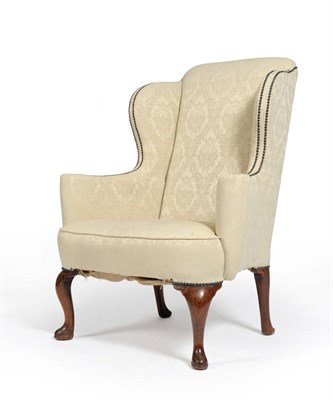 Lot 1566 - An Early Georgian Wing Back Chair, upholstered in cream silk damask, with padded back support,...