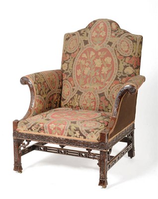 Lot 1568 - A Mahogany Framed Chippendale Wing Armchair, late 19th century, the back support, seat and C scroll