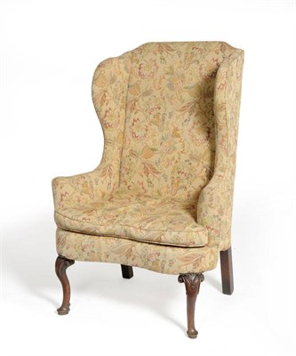 Lot 1575 - An Early Georgian Style Wing Back Chair, upholstered in modern brown floral fabric, the flared...