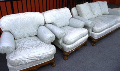 Lot 1576 - A Walnut Framed Three-Seater Settee, early 20th century, upholstered in pale blue floral silk...