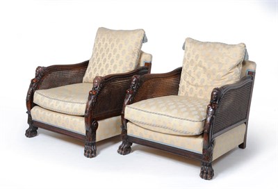 Lot 1577 - A Pair of Mahogany Bergeres, early 20th century, upholstered in modern blue silk damask with...