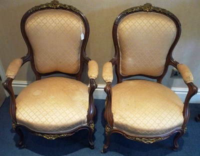 Lot 1578 - A Pair of Louis XV Style Rosewood and Gilt Metal Fauteuils, late 19th century, upholstered in beige