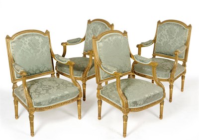 Lot 1579 - A Set of Four Louis XVI Style Gilt Open Armchairs, late 19th century, the leaf and beaded frame...