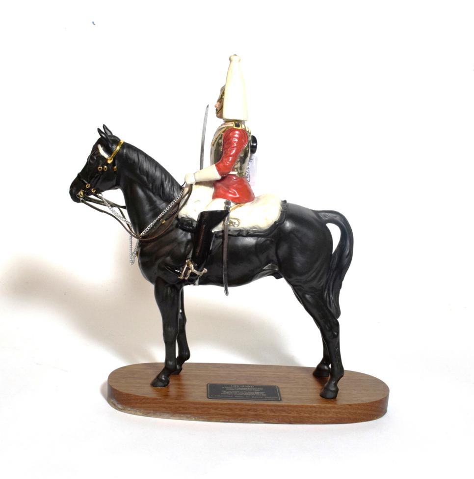 Lot 131 - Beswick Connoisseur Lifeguard, (Style two: with sword), model No. 2562, black matt, on wooden...