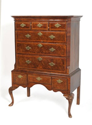 Lot 1582 - A Walnut and Feather Banded Chest on Stand, the cavetto cornice above a plain frieze with three...