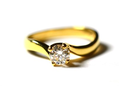 Lot 224 - An 18 carat gold solitaire diamond ring, a round brilliant cut diamond in a yellow claw setting, to