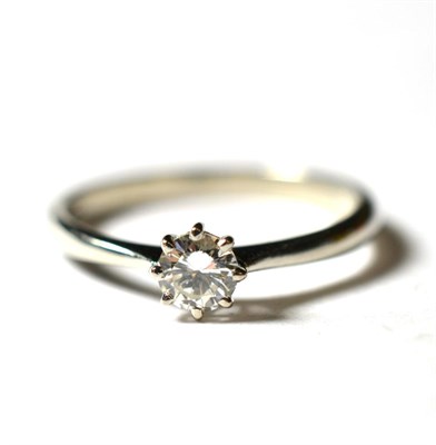 Lot 238 - A platinum solitaire diamond ring, a round brilliant cut diamond in a claw setting, to knife...