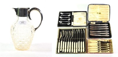 Lot 283 - Silver and enamel coffee spoons; silver handled knives; cutlery; and a plated claret jug