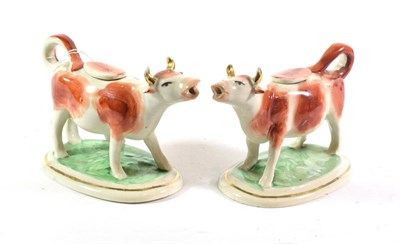 Lot 286 - A pair of cow creamers