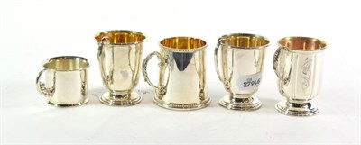Lot 317 - Five various Elizabeth II silver mugs, by Broadway and Co., Birmingham, 2004, 2006, 2007 and...