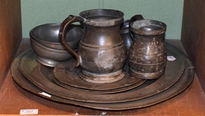 Lot 327 - A collection of antique pewter including two chargers, two footed bowls, mugs and measures etc