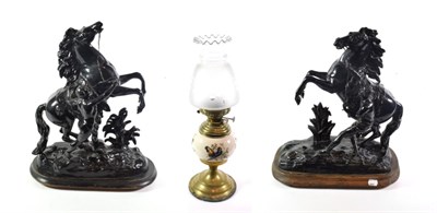 Lot 330 - A matched pair of black painted spelter Marly horses (a.f.); and a pottery and brass oil lamp...