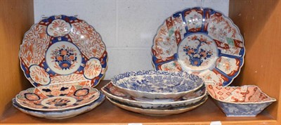 Lot 335 - 19th century Japanese porcelain including four Imari chargers, similar plate, a blue and white dish