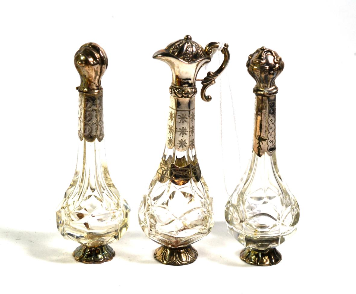 Lot 353 - Three Dutch silver-mounted glass bottles, each with differing hinged cover and engraving, one...