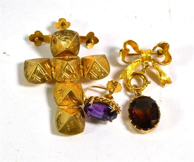 Lot 390 - A 9 carat gold citrine bow pendant/brooch, measures 2cm by 3.5cm; a single amethyst earring stamped