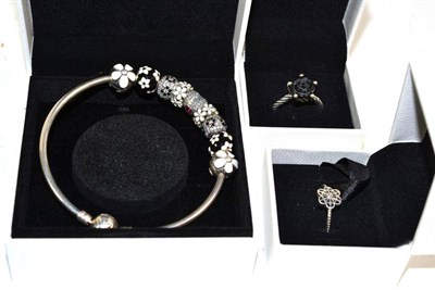 Lot 391 - Two Pandora rings, finger sizes Q and S; and a Pandora charm bracelet with nine charms, all boxed