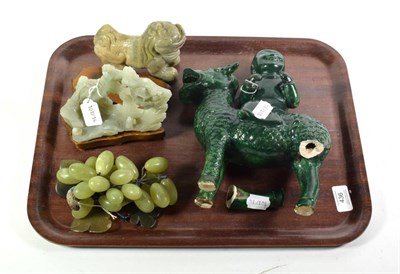 Lot 436 - A Chinese jade temple lion; with a jade landscape carving both with wooden stands; with two...