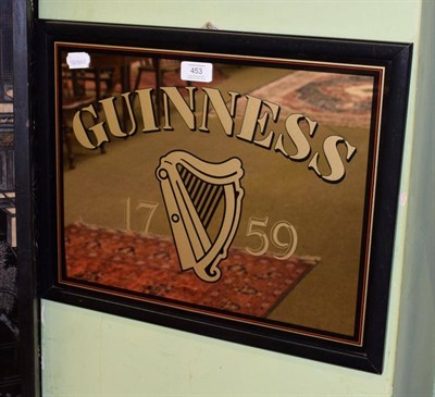Lot 453 - A Guinness pub advertising mirror with black, red and gilt border, 37cm by 47cm including frame
