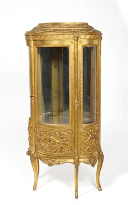 Lot 1648 - A Late 19th Century Gilt and Gesso Serpentine Form Vitrine, the staged top above an acanthus...