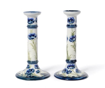 Lot 1655 - A Matched Pair of Macintyre Florian Ware "Poppy" Pillar Candlesticks, on cylindrical columns...