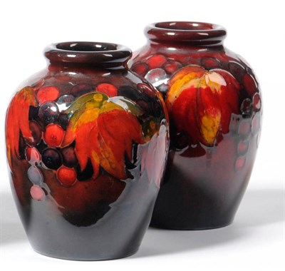 Lot 1658 - A Pair of William Moorcroft "Leaf and Berry" Flambe Vases, impressed factory mark with...