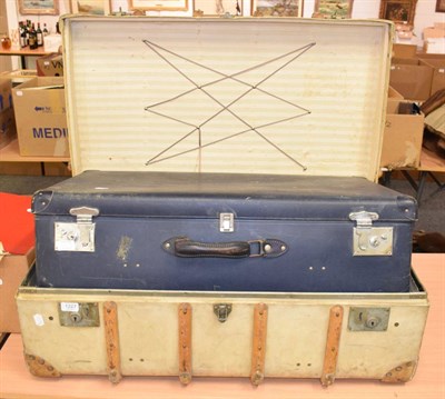 Lot 1227 - A wooden bound travelling trunk bearing old shipping labels; and a blue suitcase (2)