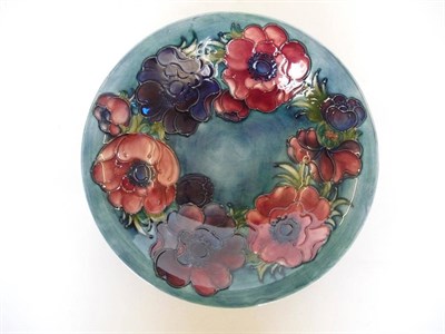 Lot 1661 - A Walter Moorcroft "Anemone" Bowl, on a blue wash ground, impressed factory mark and painted...