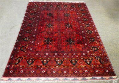 Lot 1257 - An Afghan Turkmen rug, the central field of six medallions within conforming narrow floral...