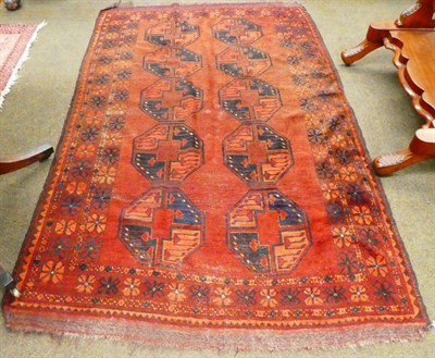 Lot 1258 - An Ersari Turkmen rug, the madder field with two columns of elephant foot guls enclosed by...