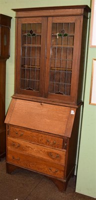 Lot 1300 - An oak bureau bookcase with leaded glass doors, circa 1900