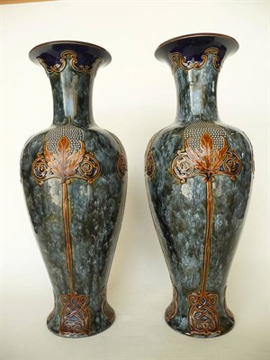 Lot 1667 - A Pair of Art Nouveau Royal Doulton Stoneware Vases, each with a repeating stylised floral...