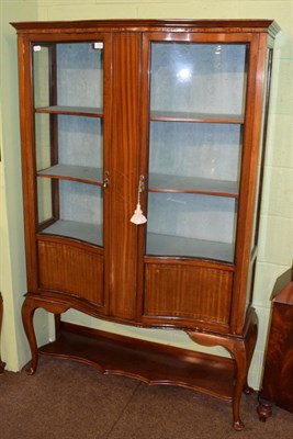 Lot 1304 - Edwardian mahogany and satinwood banded serpentine shaped display cabinet