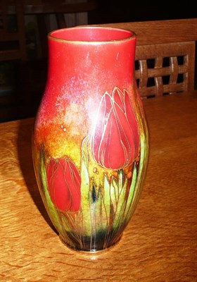 Lot 1669 - A Royal Doulton Flambe Vase, by Harry Nixon, painted and gilded with red tulips in foliage, printed