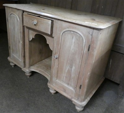 Lot 1323 - A Victorian small pine sideboard, the moulded top above a small frieze drawer and arched apron...