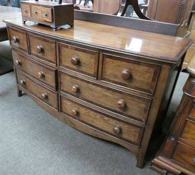 Lot 1331 - A reproduction oak chest of eight drawers in the Victorian style