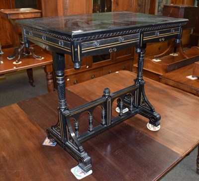 Lot 1333 - A 19th century parcel gilt ebonised occasional table with turned uprights and arched stretcher