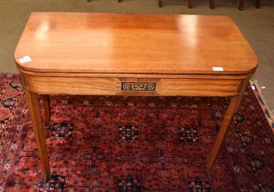 Lot 1341 - A George III mahogany and boxwood strung fold over tea table, early 19th century, with hinged...