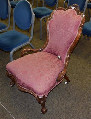 Lot 1351 - A Victorian walnut framed nursing chair, circa 1870, covered in pink and floral fabric with a...