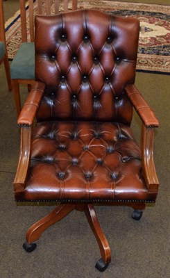 Lot 1360 - A button leather swivel office chair