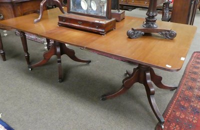 Lot 1371 - A George III style mahogany twin-pedestal dining table, with one additional leaf, on turned...