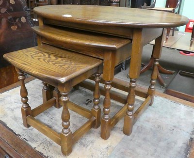 Lot 1377 - A nest of three Old Charm oak tables