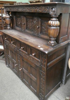 Lot 1381 - An early 20th century carved oak court cupboard