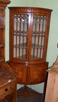 Lot 1392 - A late 19th century satinwood and ebony strung bowfront hanging corner cupboard, the arcaded...