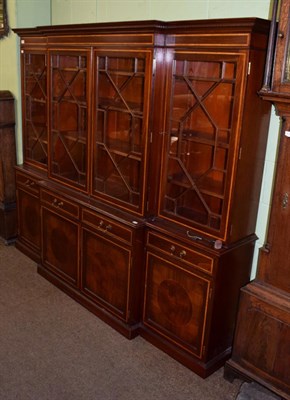 Lot 1395 - A reproduction satin wood inlaid mahogany astragal glazed break front bookcase, possibly Bevan...