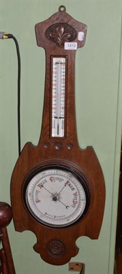 Lot 1412 - A carved oak aneroid barometer