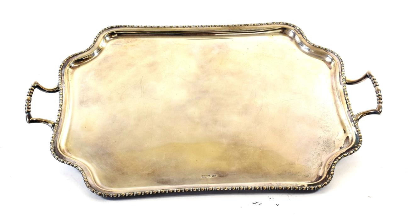 Lot 84 - A George V Silver Tray, by Atkin Bros., Sheffield, 1910, shaped oblong and with beaded rim, on four