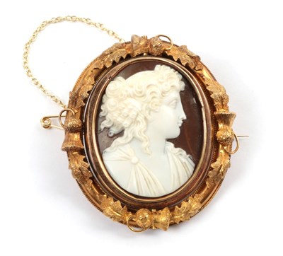 Lot 187 - A Cameo Brooch, the classical figure within a frame with thistle and leaf decoration, with a locket