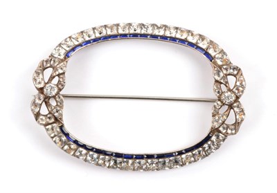 Lot 190 - A Blue and White Faceted Paste Brooch, the oval form with a white paste set bow at each end,...